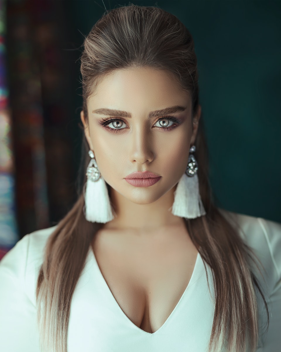 Portrait Photo of Beautiful Woman in White V-neck Top Posing