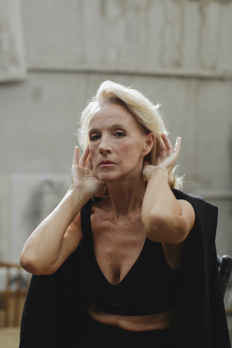 Elderly Woman in Black Brassiere Fixing her Hair