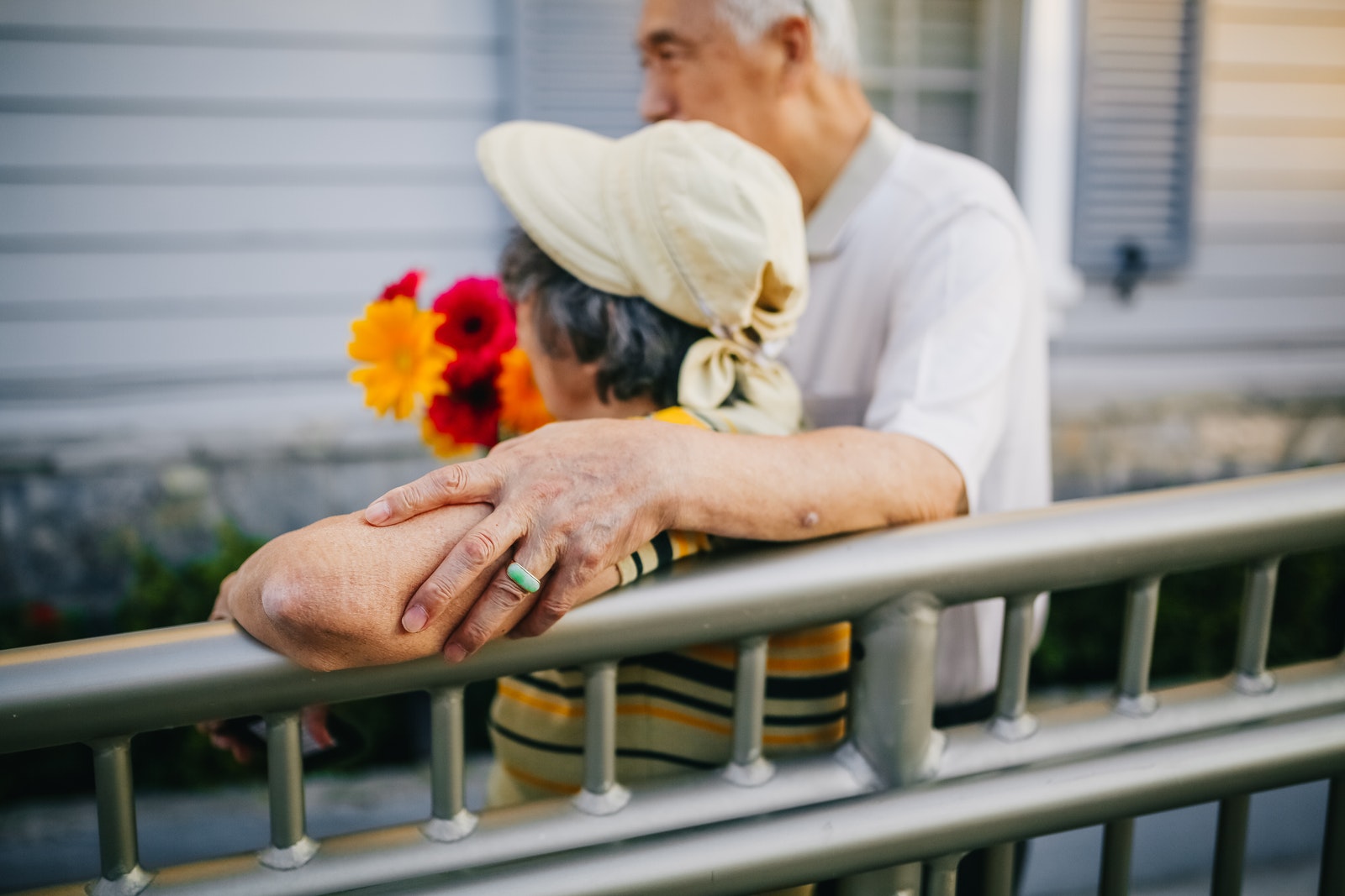 Couple Standing on the Street Holding Flowers