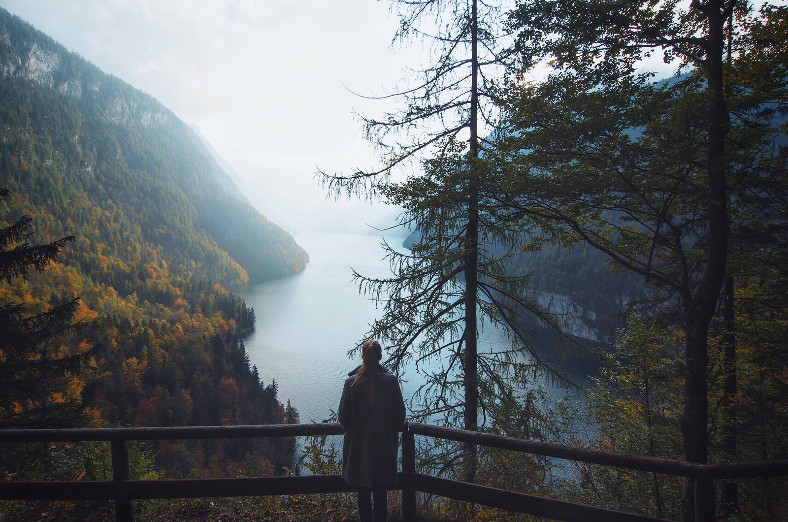 Woman Standing Overlooking the Waters Between Mountains