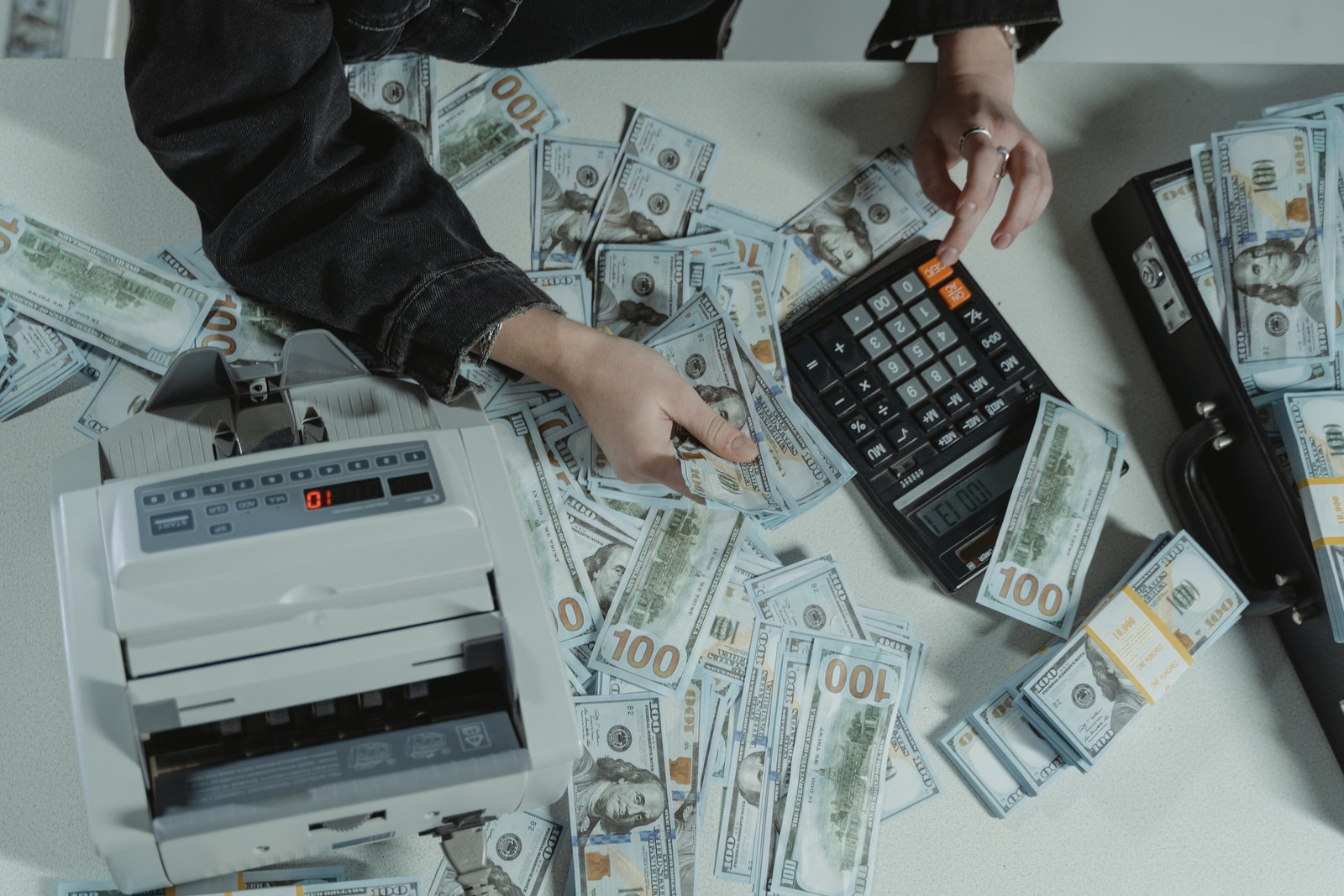 Person Holding Black and Gray Calculator