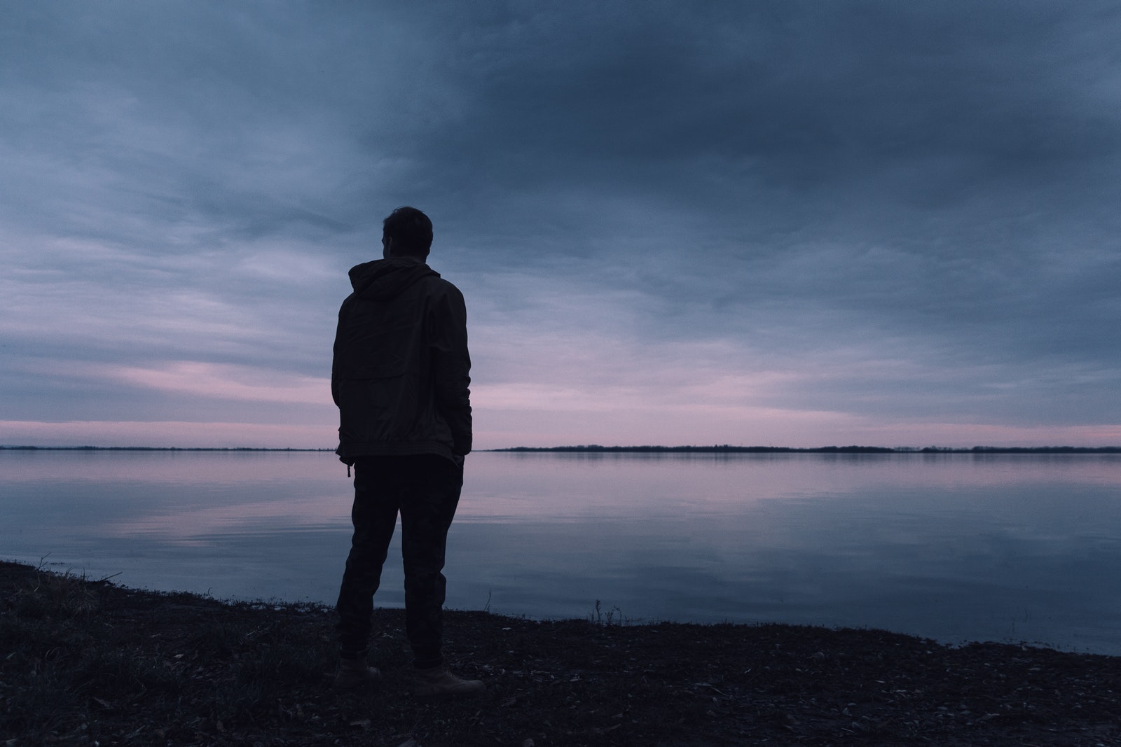 Person Standing Near Lake