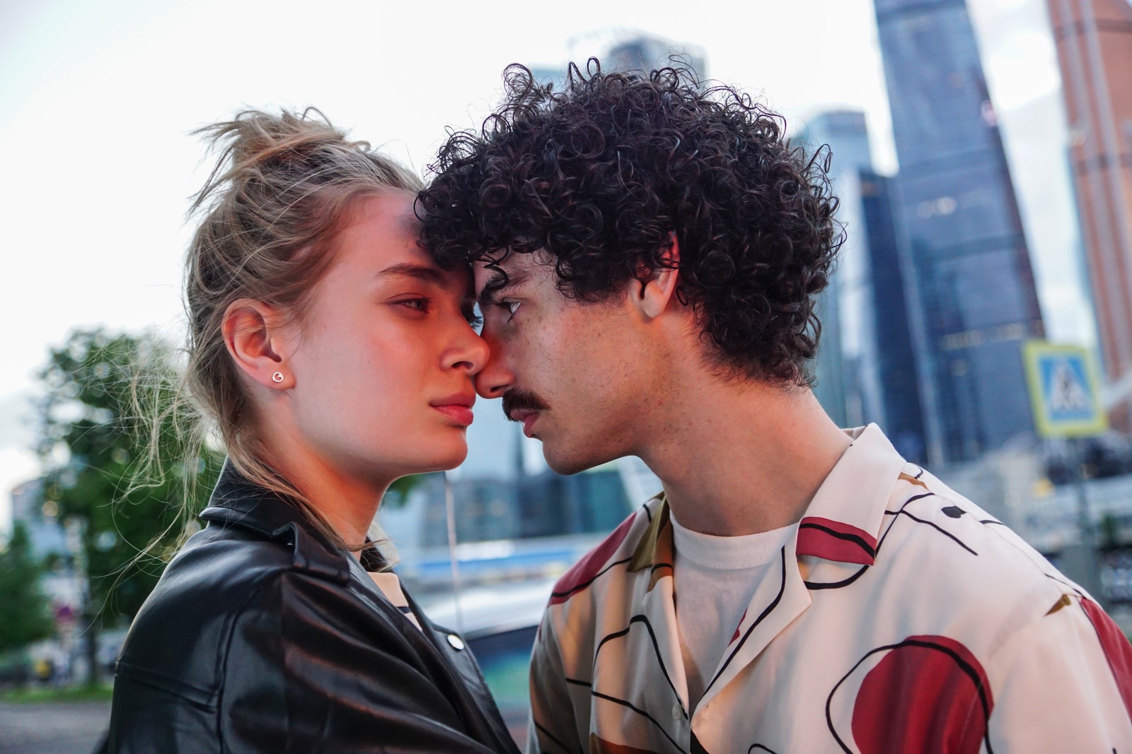 Man Leaning his Face on Woman's Face