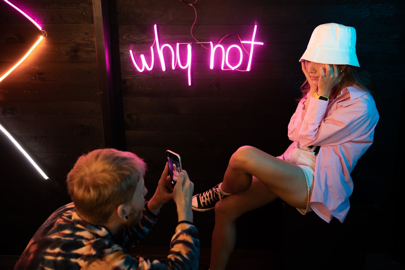 Woman in Pink Button Up Shirt Holding Smartphone