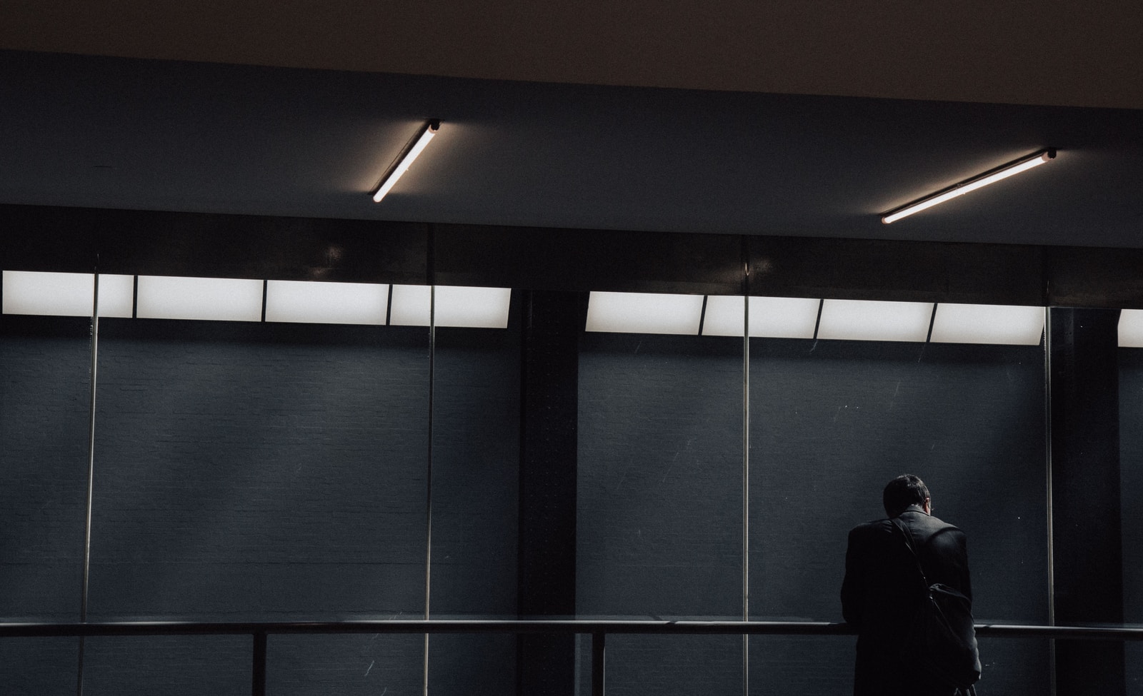 man leaning on rail