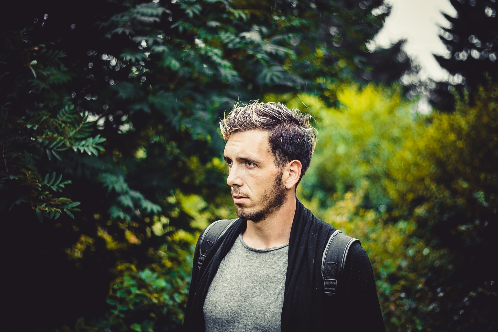 man in gray crew neck shirt and black backpack