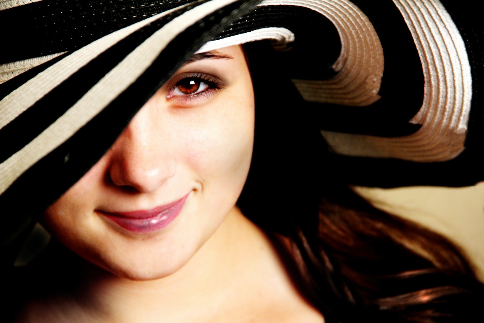 woman wearing black and white hat